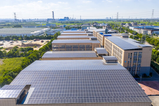 Solar panels installed on industrial factory building rooftops for clean energy generation