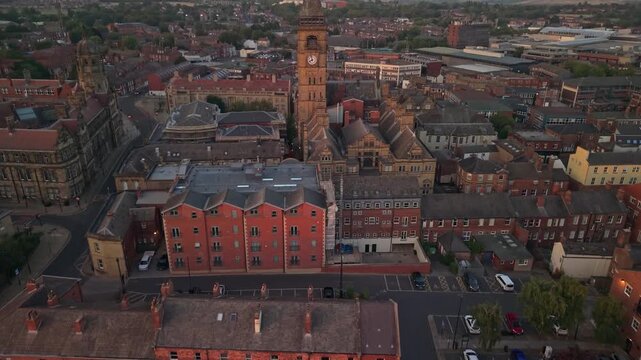 Drone POV of Wakefield Town hall and city centre in sunset, golden hour. Aerial view of Wakefield, a cathedral city located on the River Calder in West Yorkshire, England, United Kingdom. 