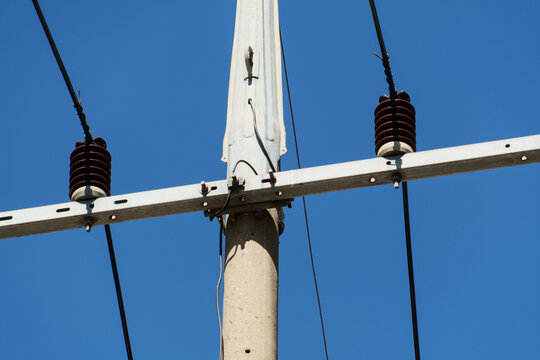 Power distribution insulators and cables on concrete utility pole