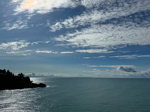 Cloudy sky over calm glittering sea 