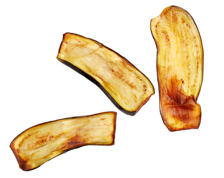 Slices of fried eggplant stand isolated against a white background. The edges are charred, while the interior is soft and golden.