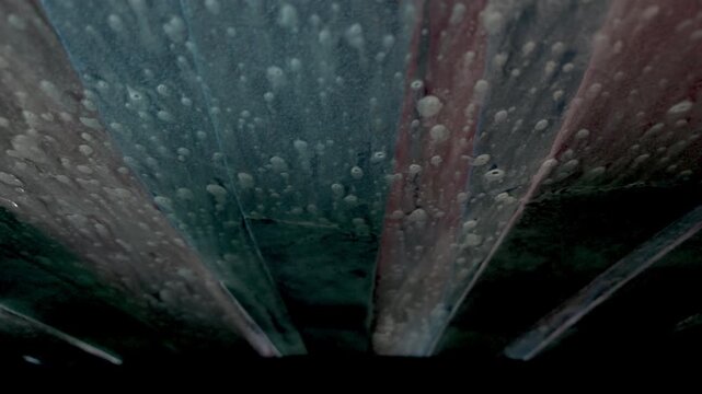 POV from Inside a Car Driving Through an Automatic Car Wash Tunnel with Soap and Brushes