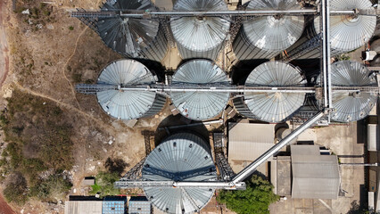 Top down view of industrial steel grain silos used for agricultural storage at a facility © Salsabila Ariadina