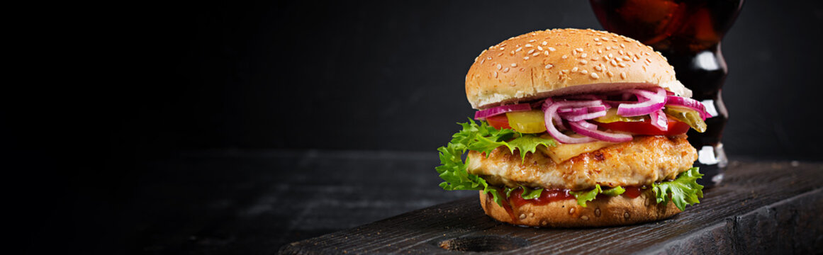 Chicken hamburger. Sandwich with chicken burger, tomatoes, cheese and lettuce. Cheeseburger. Banner