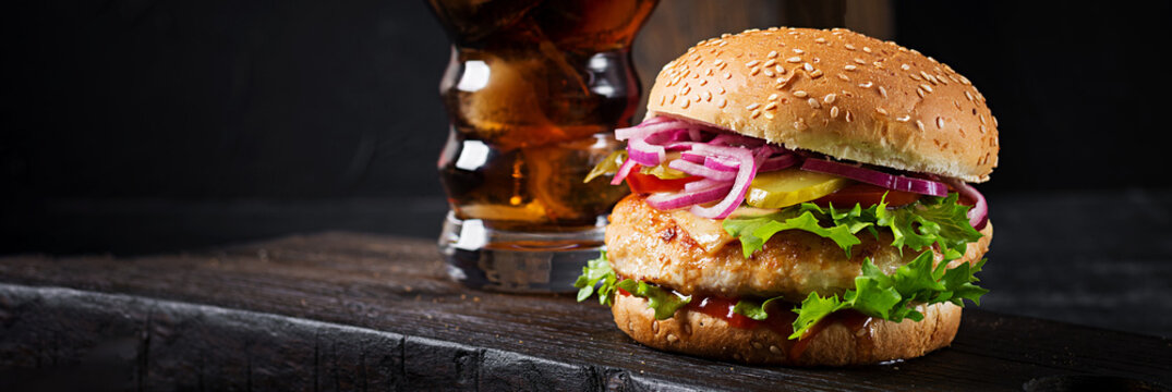 Chicken hamburger. Sandwich with chicken burger, tomatoes, cheese and lettuce.  Banner