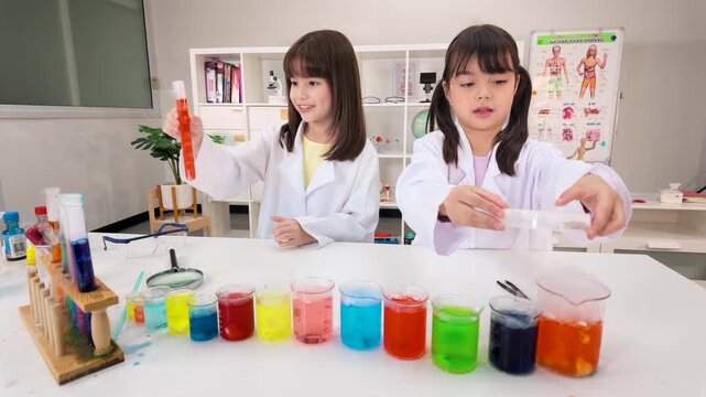 Two Schoolgirls in Lab Coats Conducting Colorful Science Experiments