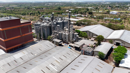 Industrial grain storage silos and warehouses surrounded by vegetation in South Kalimantan © Salsabila Ariadina