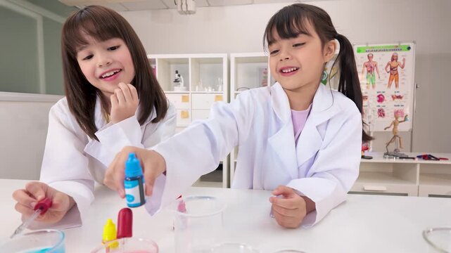 Two Schoolgirls Conducting Colorful Chemistry Experiments in Classroom Laboratory