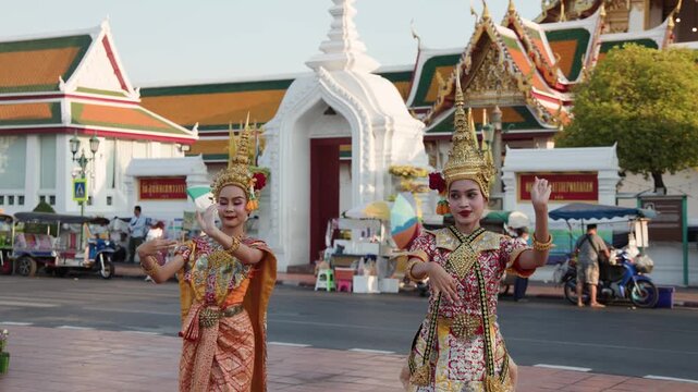 Thai Traditional Dancers Performing in Golden Khon Costumes Outside Bangkok Temple