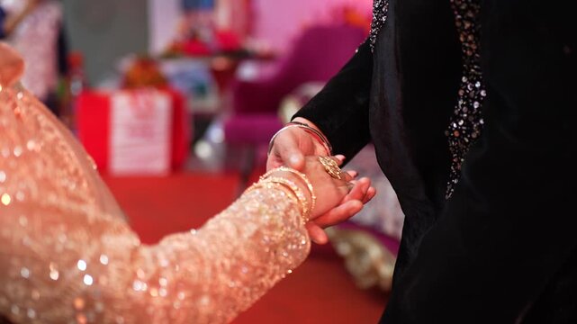 Indian couple holding hands during a traditional marriage ceremony in Lucknow