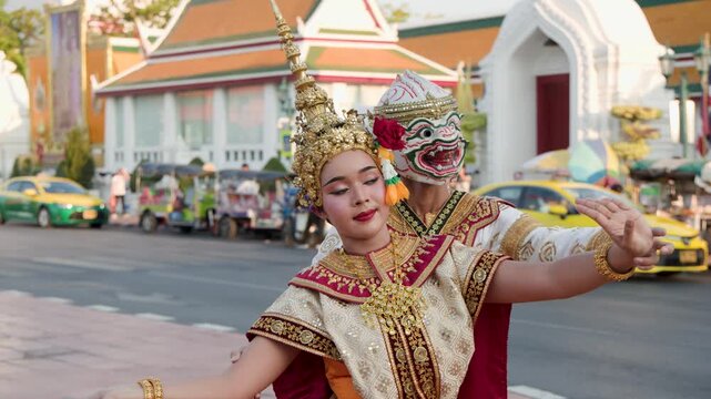Performers in Traditional Thai Khon Dance Costumes Dancing Outdoors