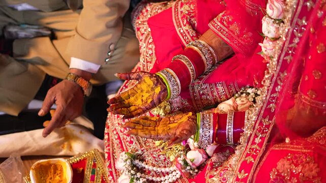 Indian bride with turmeric paste on hands during wedding ceremony in Lucknow