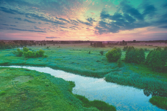 Aerial view of countryside and brook on a spring sunny day. Beautiful nature landscape in spring