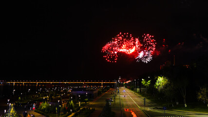 Fototapeta premium Fireworks over a bridge at night.