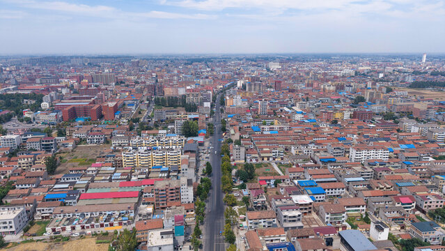 Aerial view of small Chinese city with dense residential buildings under blue sky