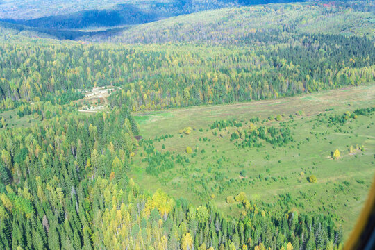 Aerial view from the window of a helicopter on the autumn forest