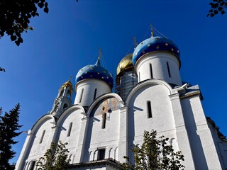Historic church with blue and gold domes under clear sky © Alexander