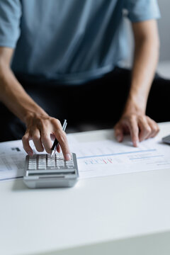 male calculating personal financial for future plan at his home, taxes payment