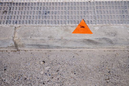 Sticker placed on the roadway indicating that police has removed an illegally parked vehicle.