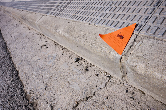 Sticker placed on the roadway indicating that police has removed an illegally parked vehicle.