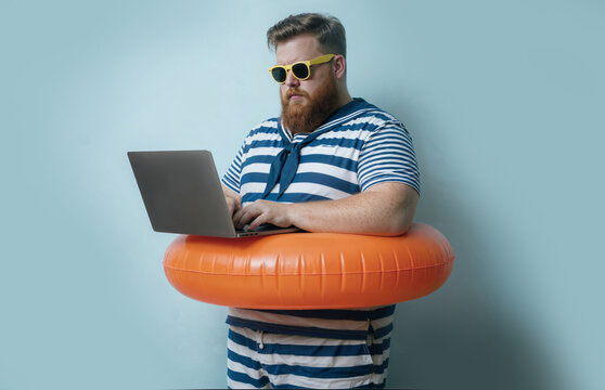 Funny Sailor Man with Lifebuoy Using Laptop