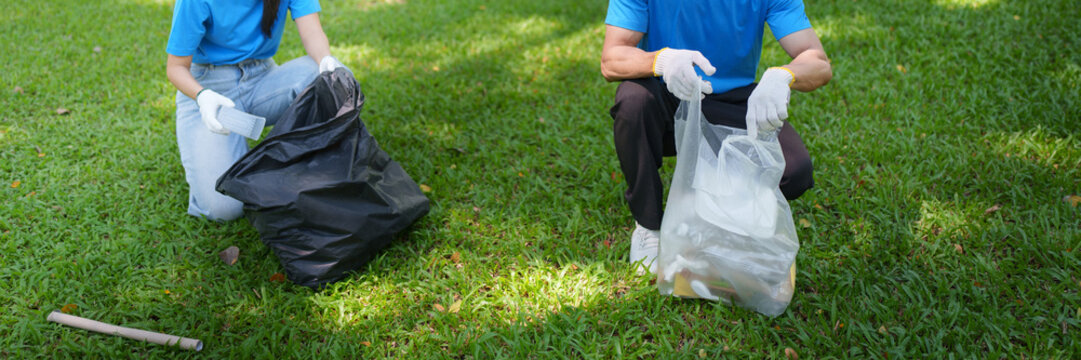 Volunteers picking up garbage and sorting waste on park lawn