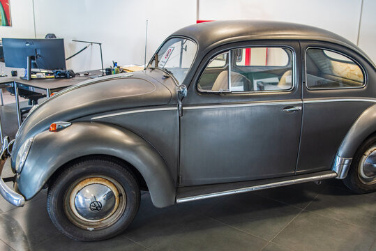 OFFENBACH, GERMANY - JULY 25, 2025: Vintage grey Volkswagen Beetle Type 1 on display inside a car dealership showroom
