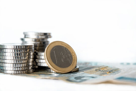 1 euro close-up: coins and banknotes. Economy, Europe, business, finance, cash, and money-saving concept.
