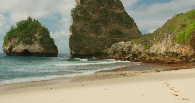Solo traveler woman exploring ocean at Diamond Beach Nusa Penida Bali