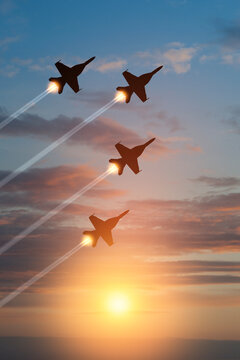 Air Force Day. Aircraft silhouettes on background of sunset. Combat flight of interceptors on a mission. Vertical poster.