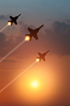Air Force Day. Aircraft silhouettes on background of sunset. Combat flight of interceptors on a mission. Vertical poster.