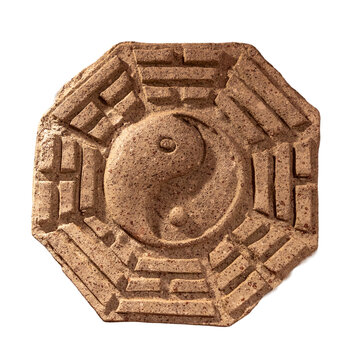 Octagonal stone carving of a Bagua trigram tile with a central Yin Yang symbol.