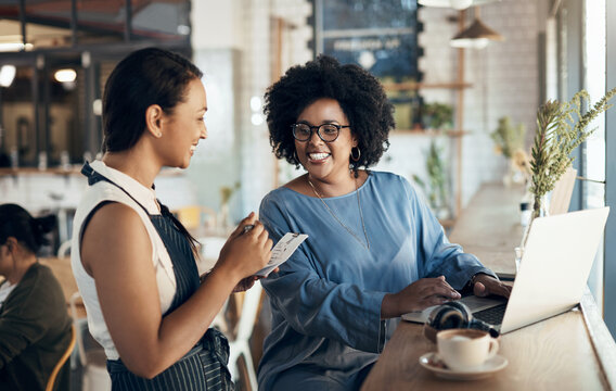 Smile, waitress and woman at cafe with notepad, customer order and menu options for dining service. Happy, server and freelancer at coffee shop with laptop, food recommendation and special request