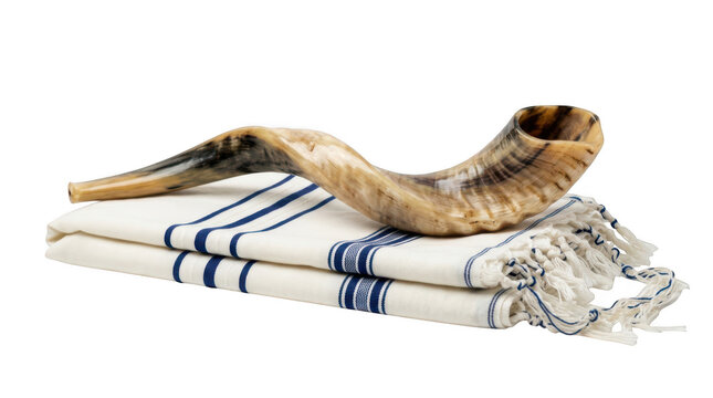 Shofar horn resting on a traditional jewish tallit prayer shawl isolated on transparent background