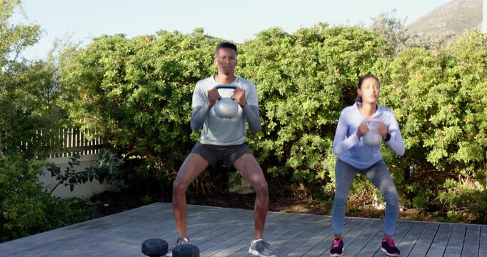 Lifestyle videos outdoor of people doing activities, exercising outdoors, man and woman lifting dumb