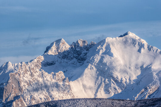 View of the snow-covered peaks of the Apennine Mountains under a clear blue sky, Abruzzo, Italy.