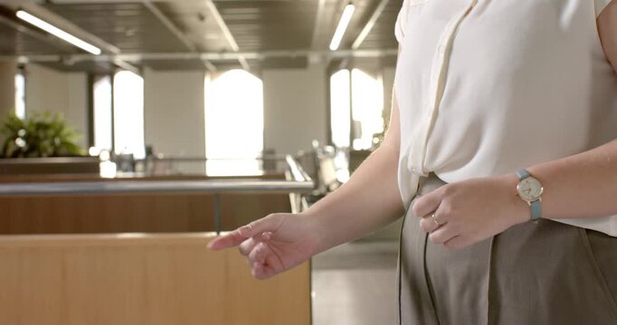 Close up of people talking to the camera, pointing and giving directions, woman in office environmen