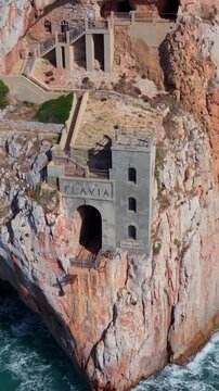 Aerial view of the Porto Flavia sign and historic mining port on the coast of Sardinia