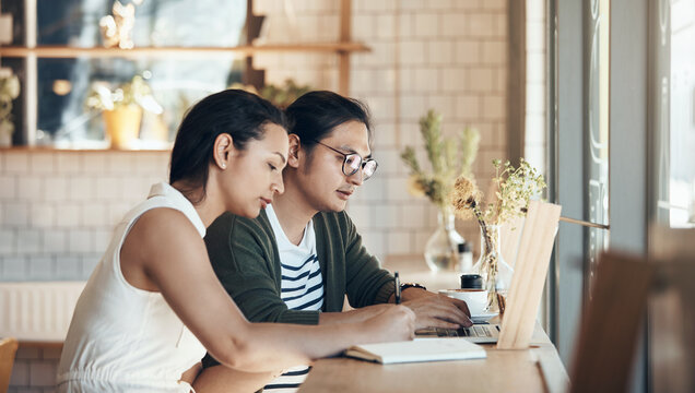 Business, couple and owner at cafe with laptop, research and menu planning for inventory audit. People, writing and notebook at coffee shop with tech, stocktaking and pricing update for online orders