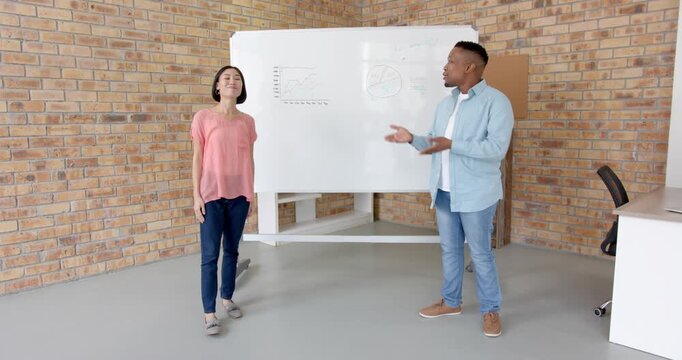 Lifestyle videos indoor of people doing activities at office, presenting data on whiteboard, man exp