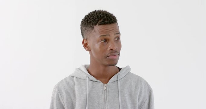 High speed photography for dynamic scenes, Looking up, man in grey hoodie appearing thoughtful.