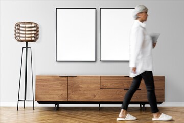 Obraz premium Modern minimalist interior with walking woman and blank frames