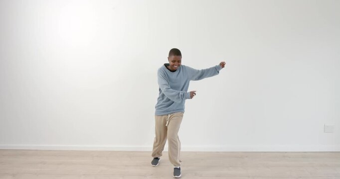High speed photography for dynamic scenes, Dancing joyfully, boy in casual clothes enjoying movement