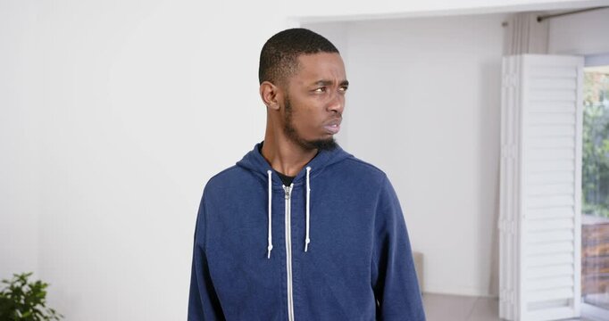 High speed photography for dynamic scenes, man in blue hoodie looking away with thoughtful expressio