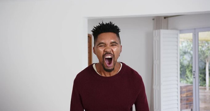 High speed photography for dynamic scenes, man in maroon sweater laughing loudly in bright indoor se