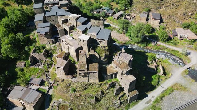 Top-down aerial drone footage of Shatili showing the interconnected stone walls, flat roofs and dense arrangement of buildings within the fortified village.