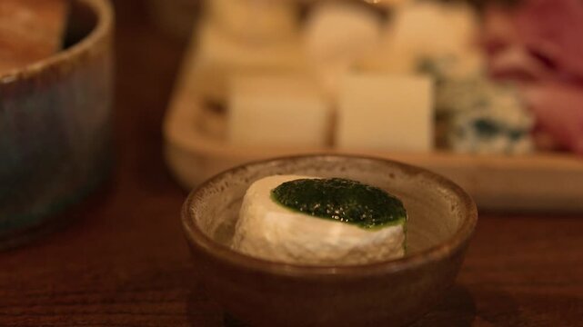 Fresh Goat Cheese with Herb Sauce on Gourmet Appetizer Board