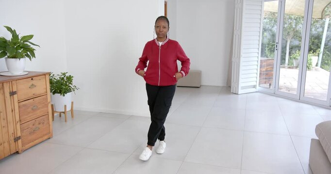 High speed photography for dynamic scenes, woman in red jacket dancing indoors, enjoying music in sp