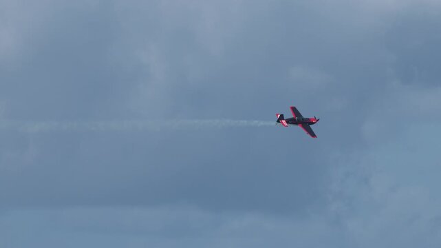 Stunt Plane Performing Aerobatics and Barrel Rolls With Smoke Trail