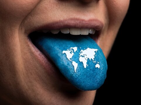 Person sticking out blue tongue with world map print